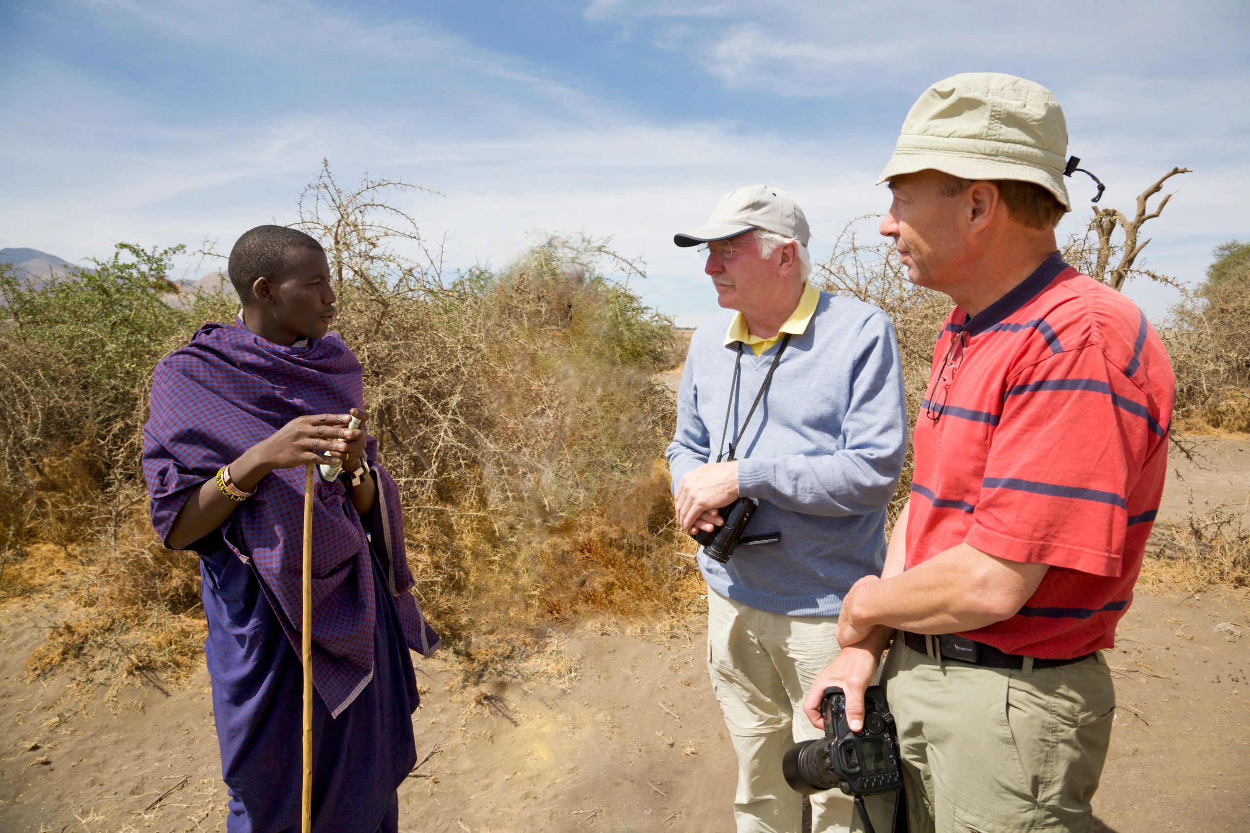 Local guide with travellers during a cultural experience in Tanzania