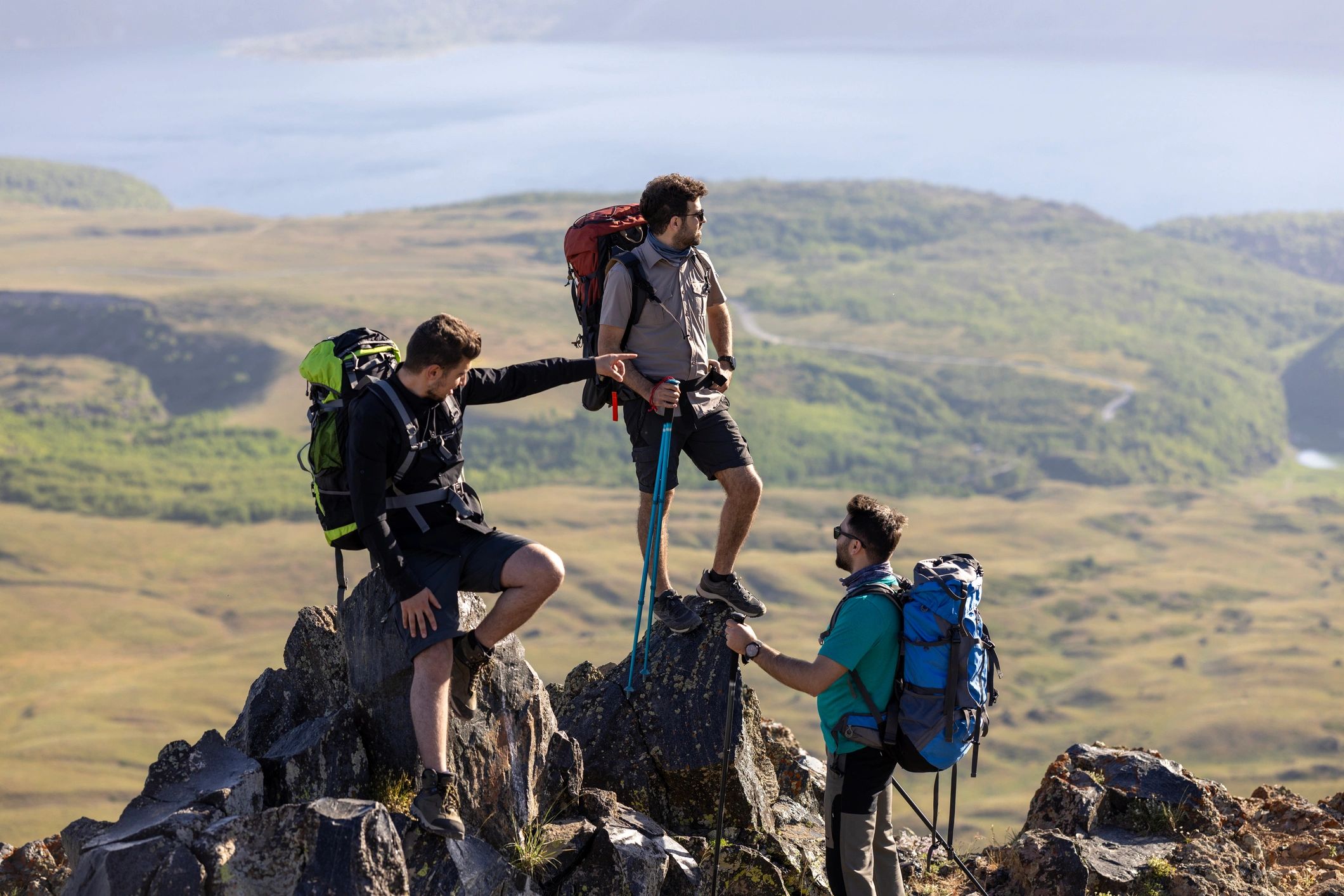 Mountaineers walking up a rocky slope in sunshine
