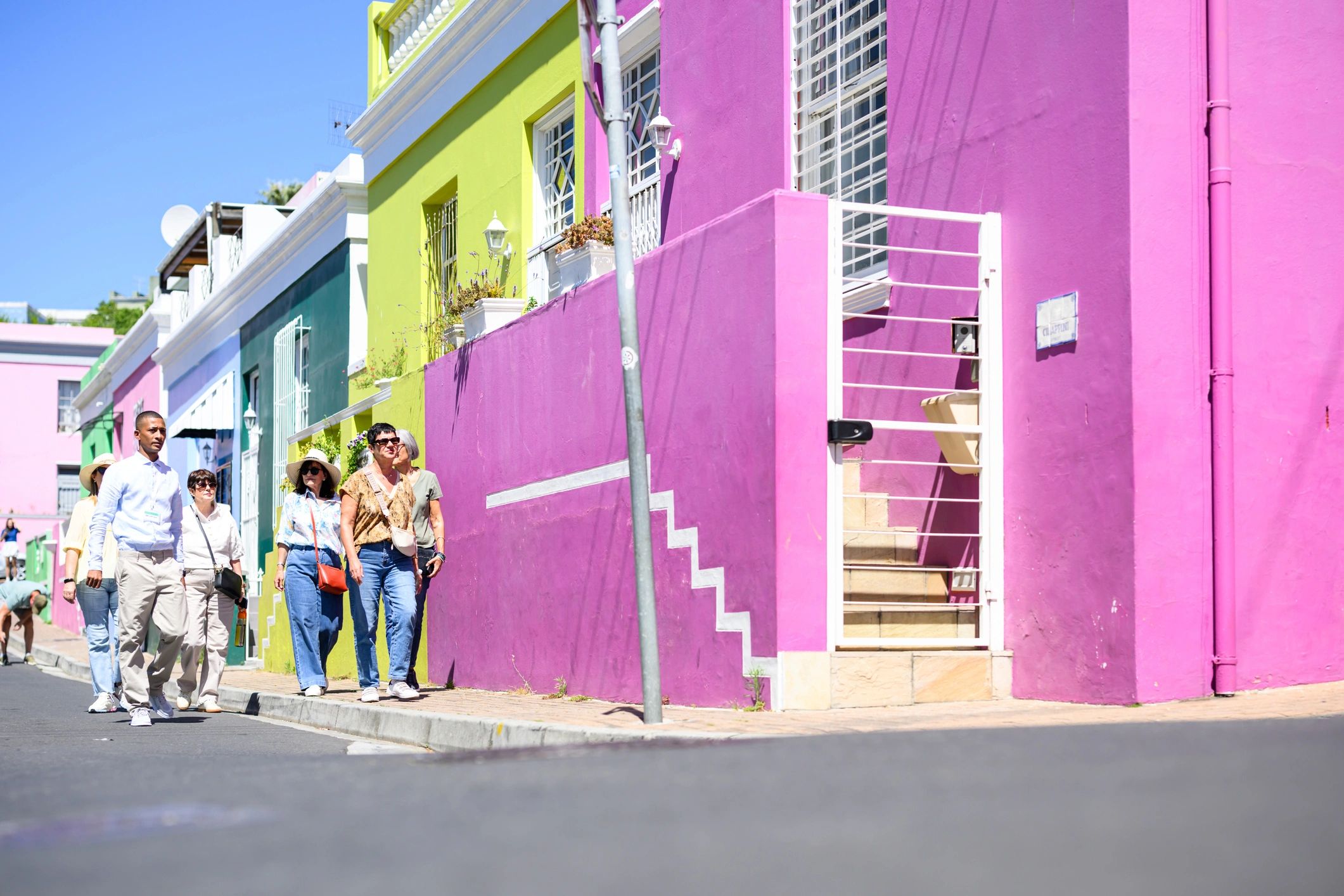 Travellers walking through a colourful neighbourhood