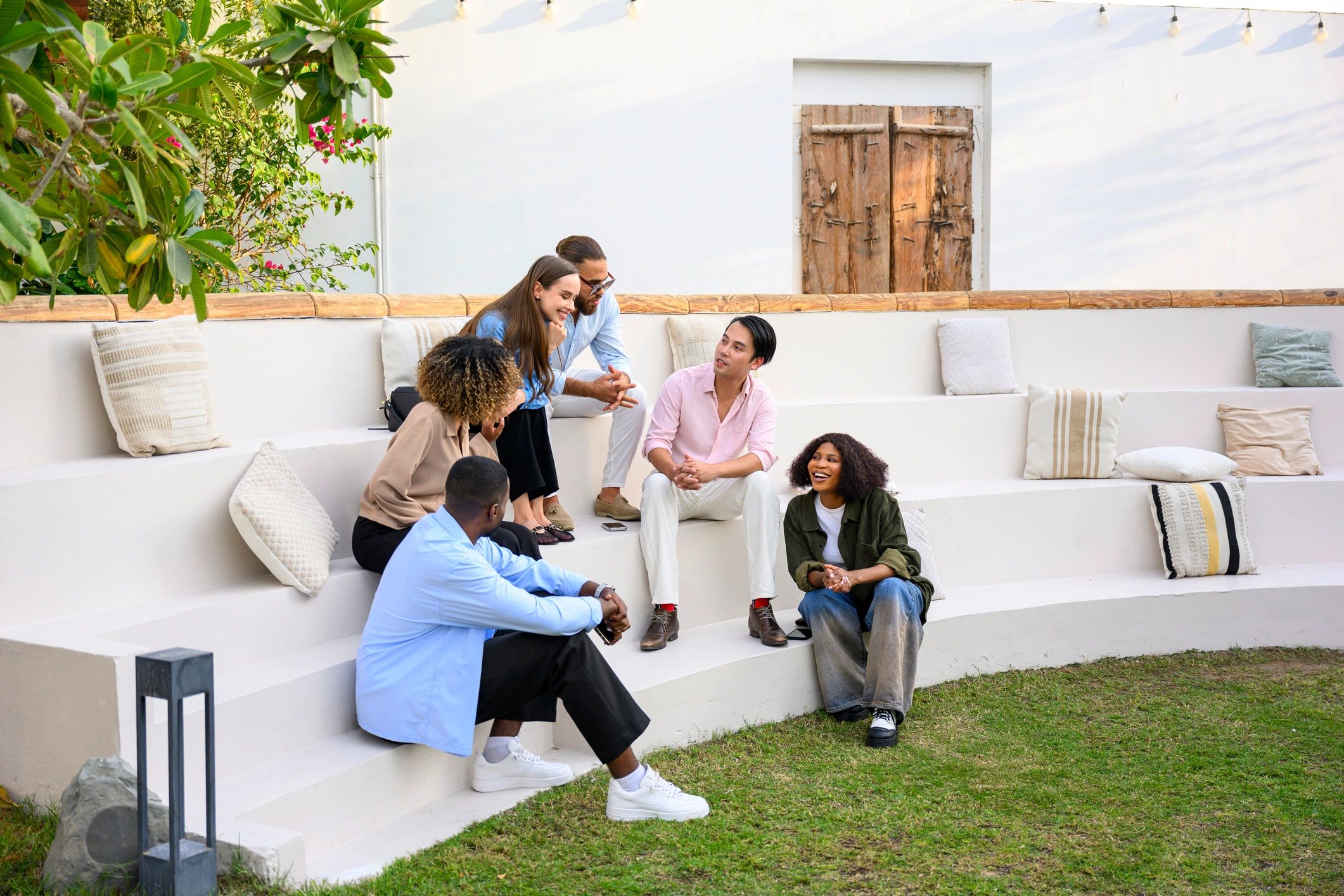 Friends enjoying conversation on outdoor patio amphitheater seating